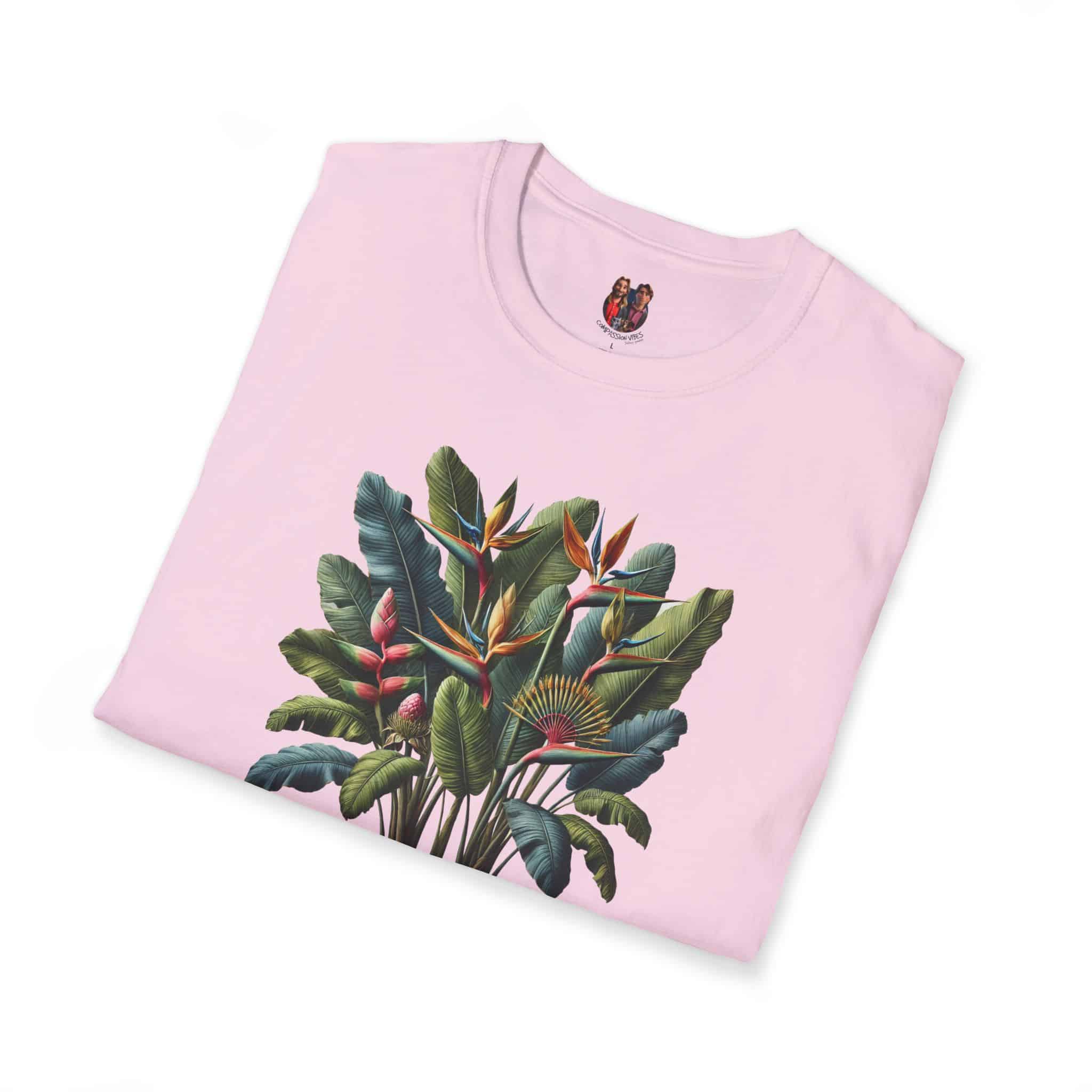 Pink T-shirt featuring a vibrant tropical plant design with leaves and flowers.