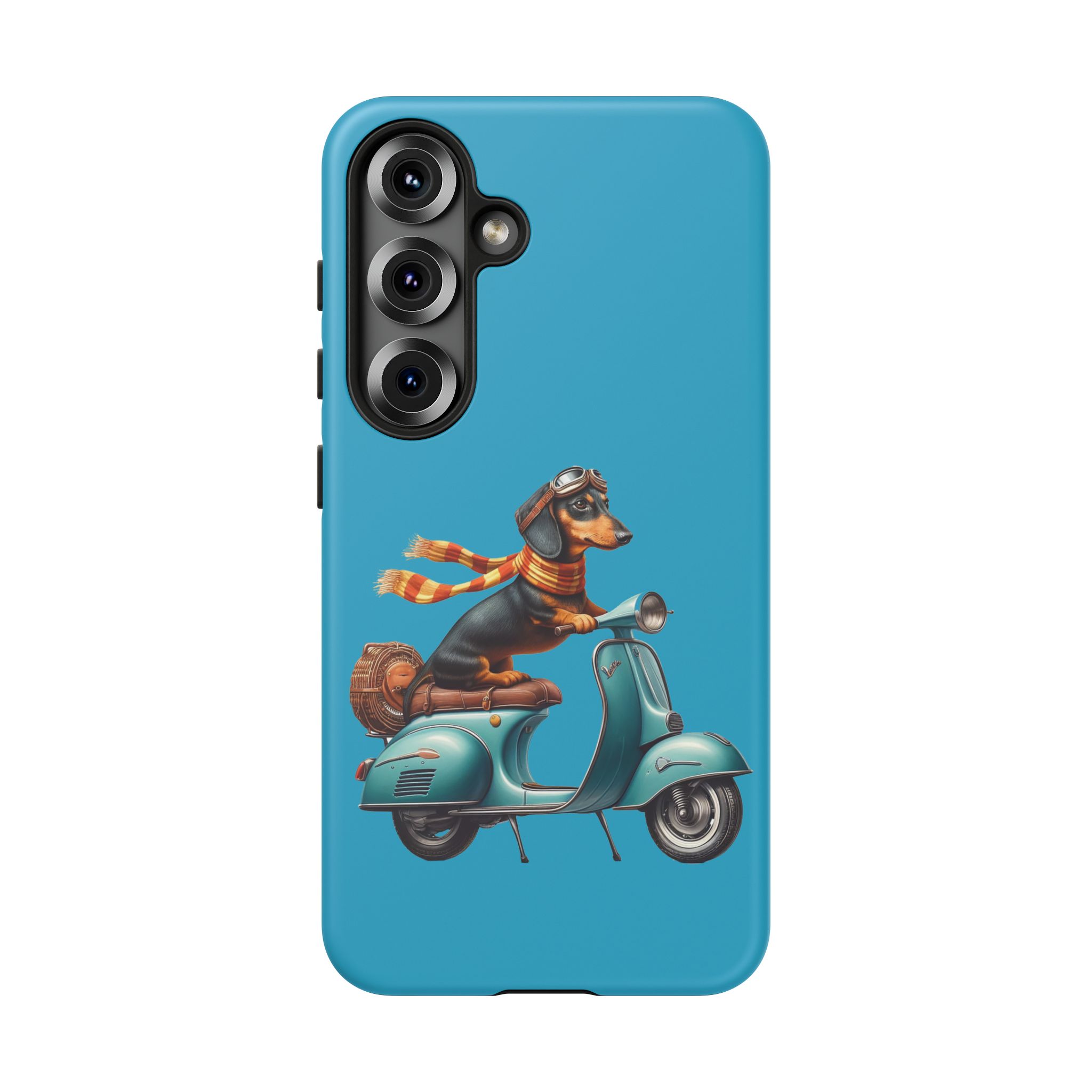 A dachshund wearing goggles and a scarf riding a teal scooter with a brown bag.
